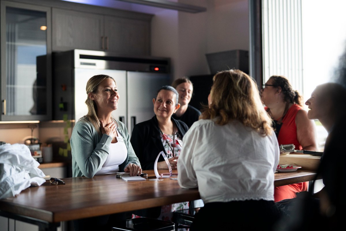 Women in conversation around a table at an ATHENA event